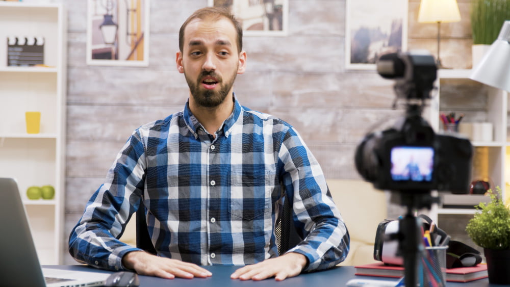 excited influencer while recording his vlog living room famous creative man